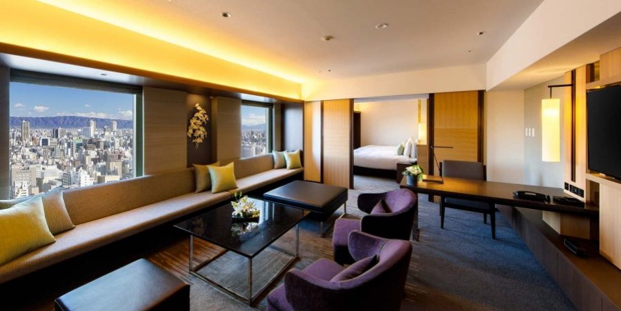 A stylish hotel room showcasing a breathtaking view of the bustling city below.